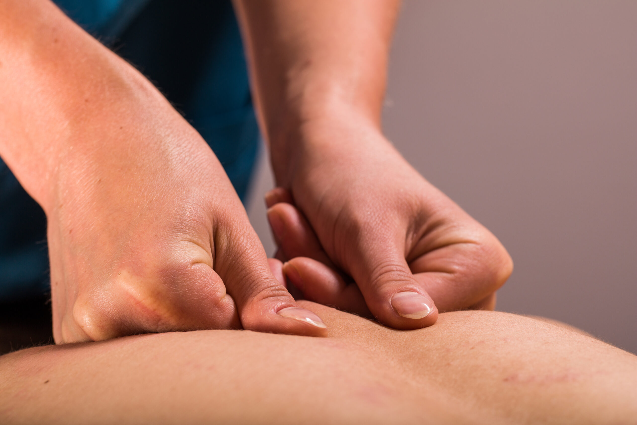 A close-up of someone receiving a deep tissue massage as part of their massage therapy treatment.
