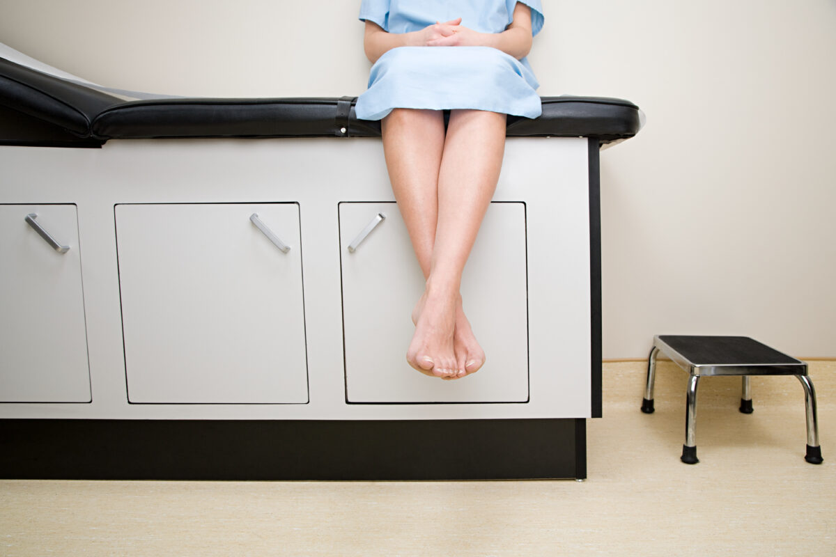 A woman with nervous legs syndrome awaiting diagnosis in a doctor's office.