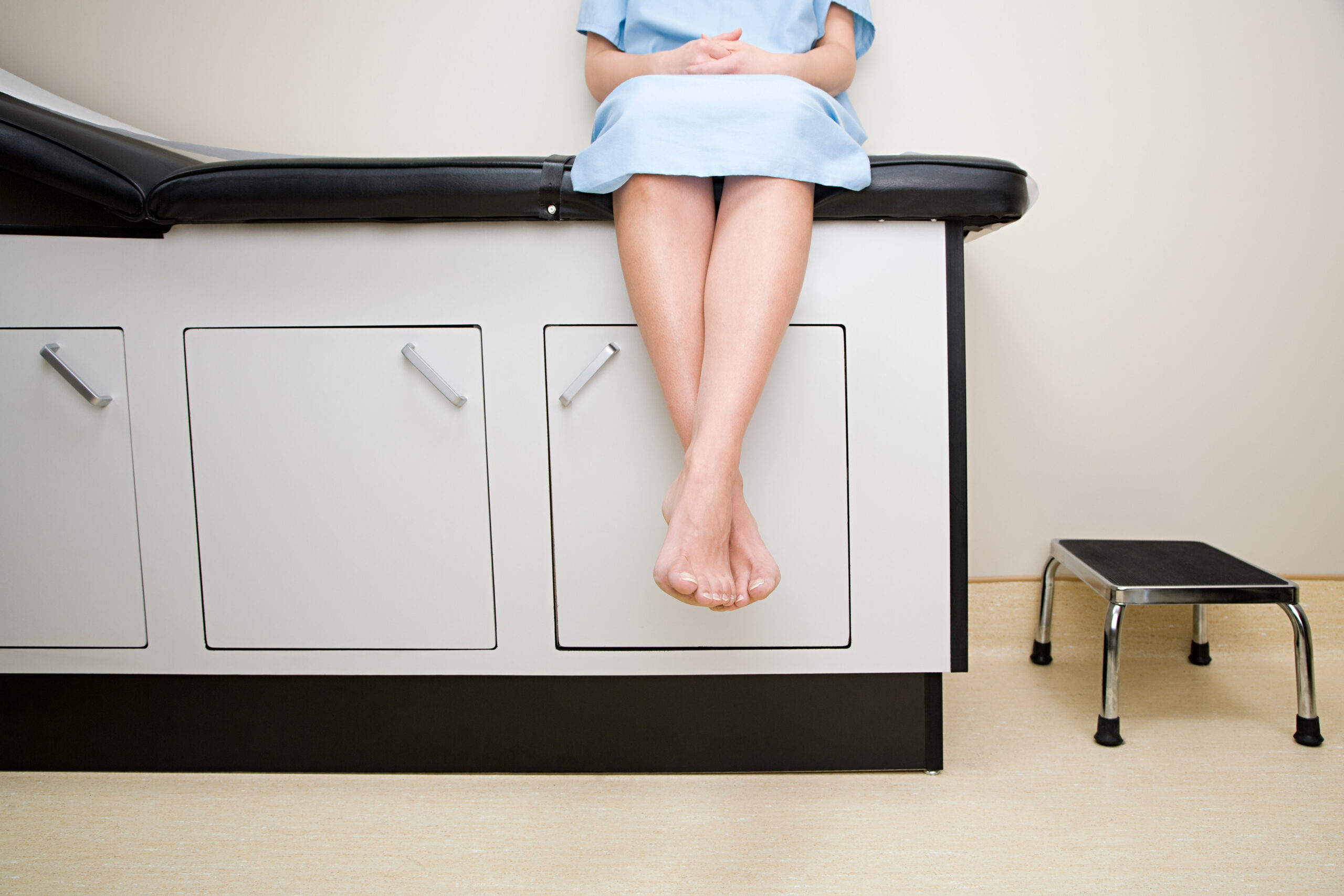 A woman with nervous legs syndrome awaiting diagnosis in a doctor's office.
