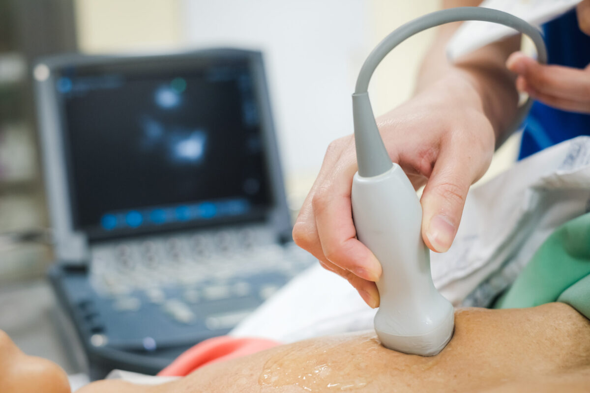 Advanced cardiac diagnostics in NJ being performed by a doctor on a patient's chest via an ultrasound.