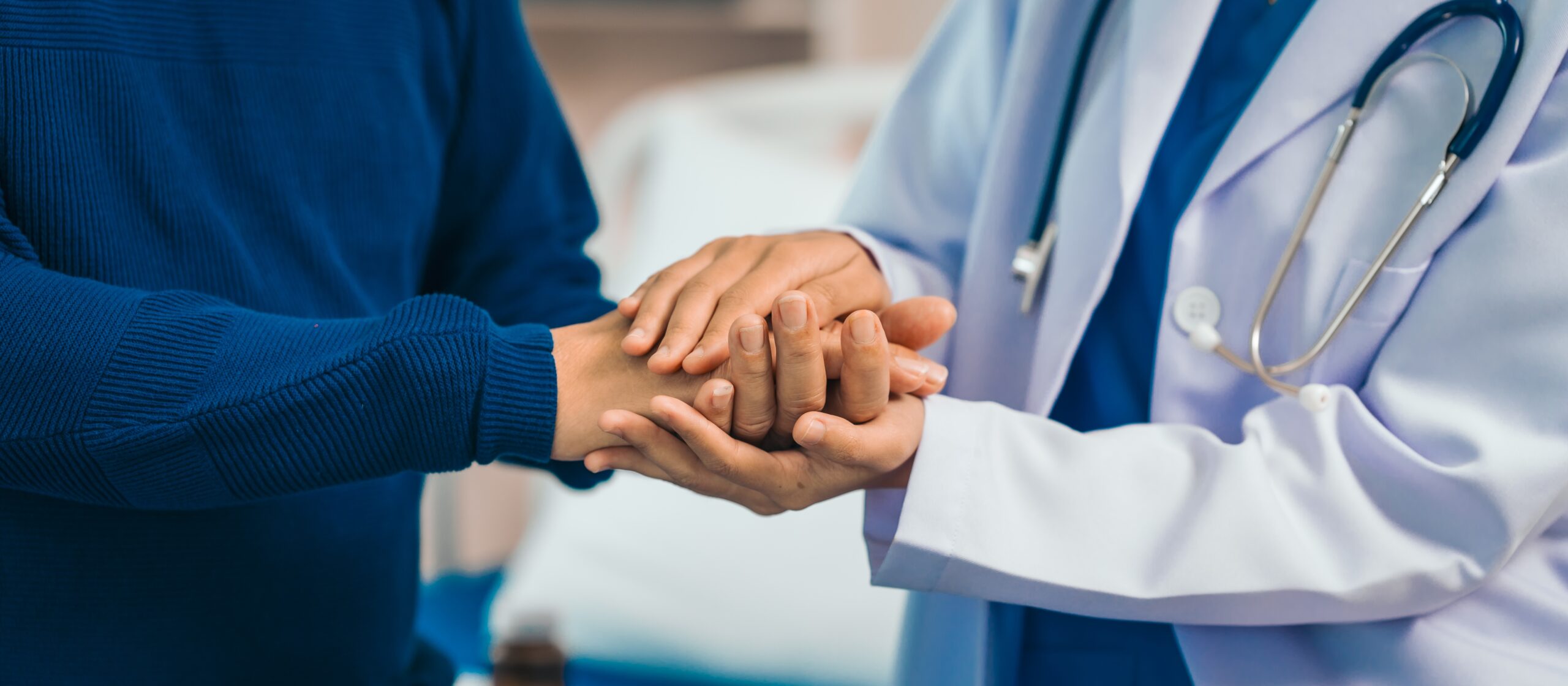 A close-up of a doctor holding their patient's hands, discussion their comprehensive men's and women's health services in NJ.