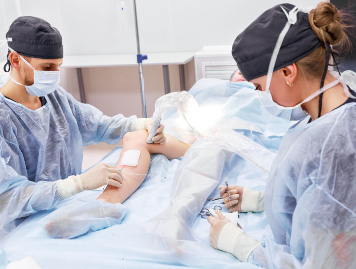 A pain management specialist doctor performs deep vein ablation treatment on a patient during minimally invasive surgery.