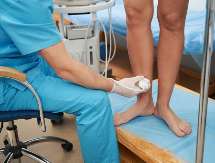 A pain management specialist provides a patient radio frequency treatment for varicose veins.