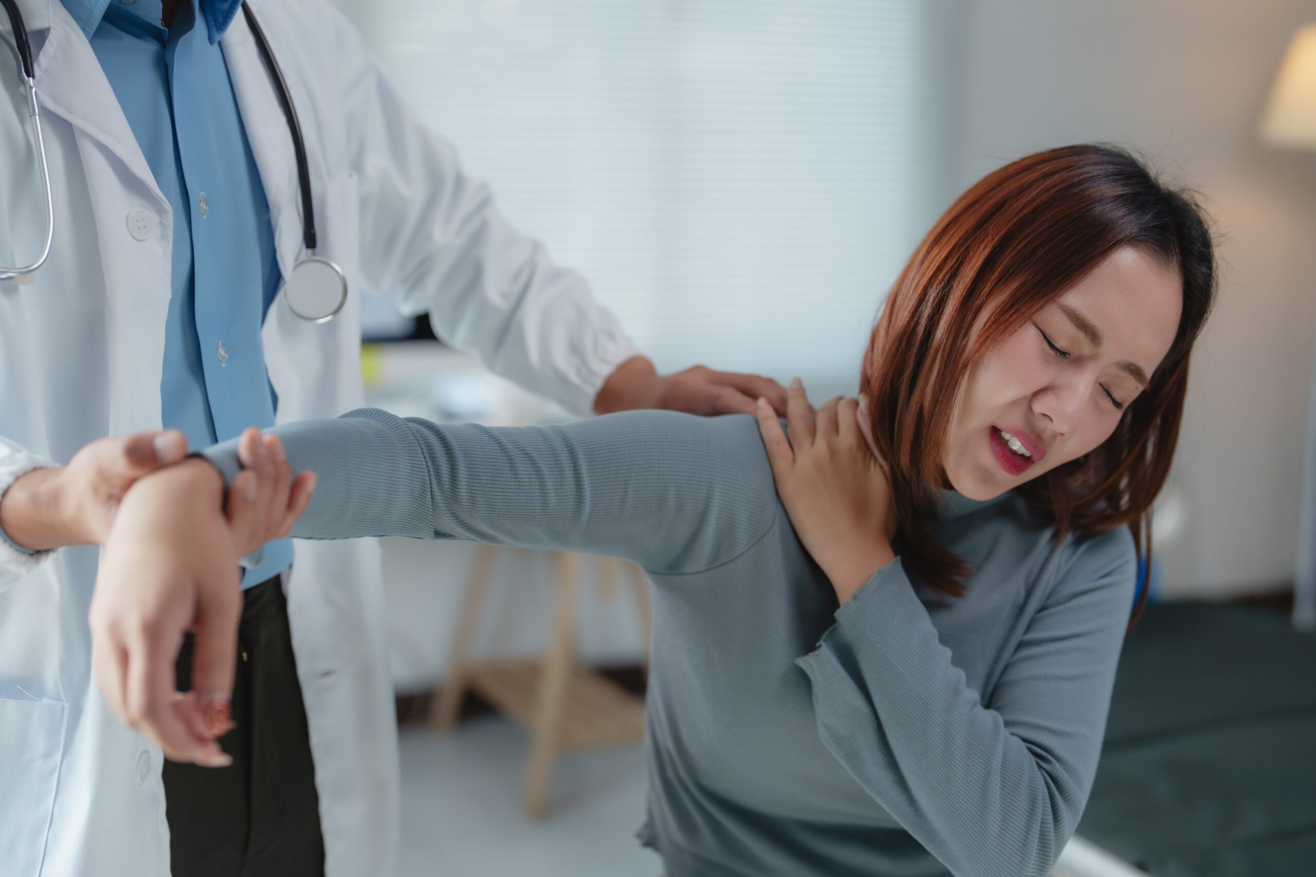 Pain management physicians, like the one assisting this female patient with her shoulder, are experts in making your daily life manageable.