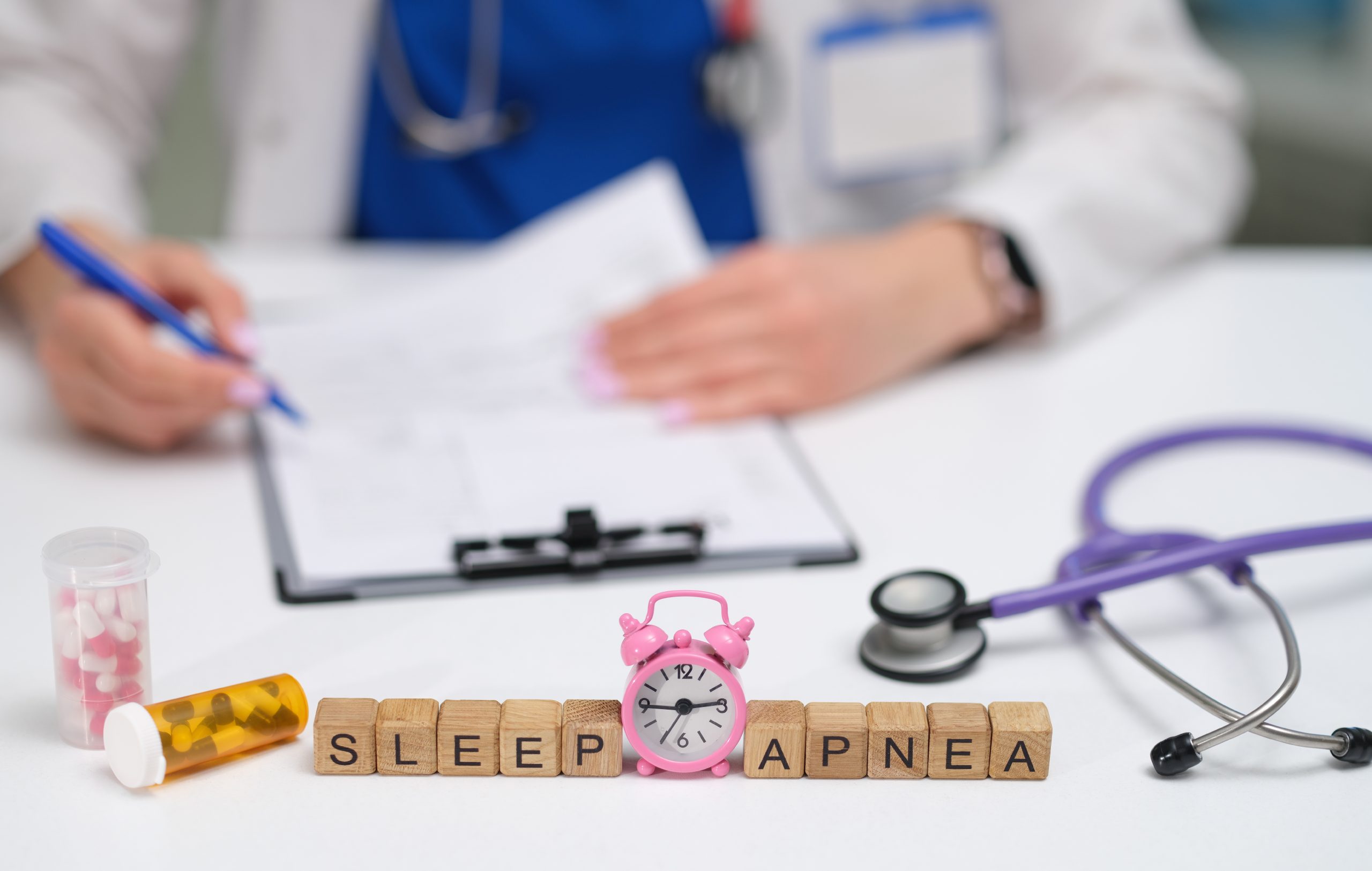 Sleep apnea spelled out in wooden blocks on a doctor's desk.