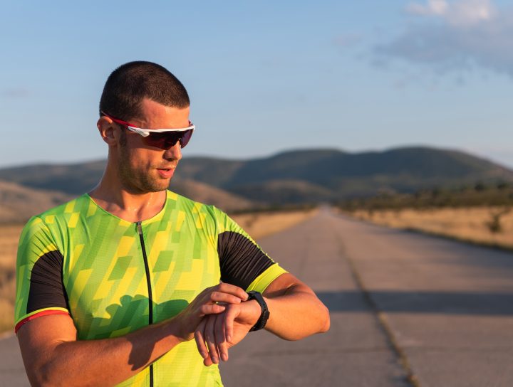 A runner on the road takes a break to check his vitals on a smartwatch after experimenting with an oral appliance for sleep apnea.
