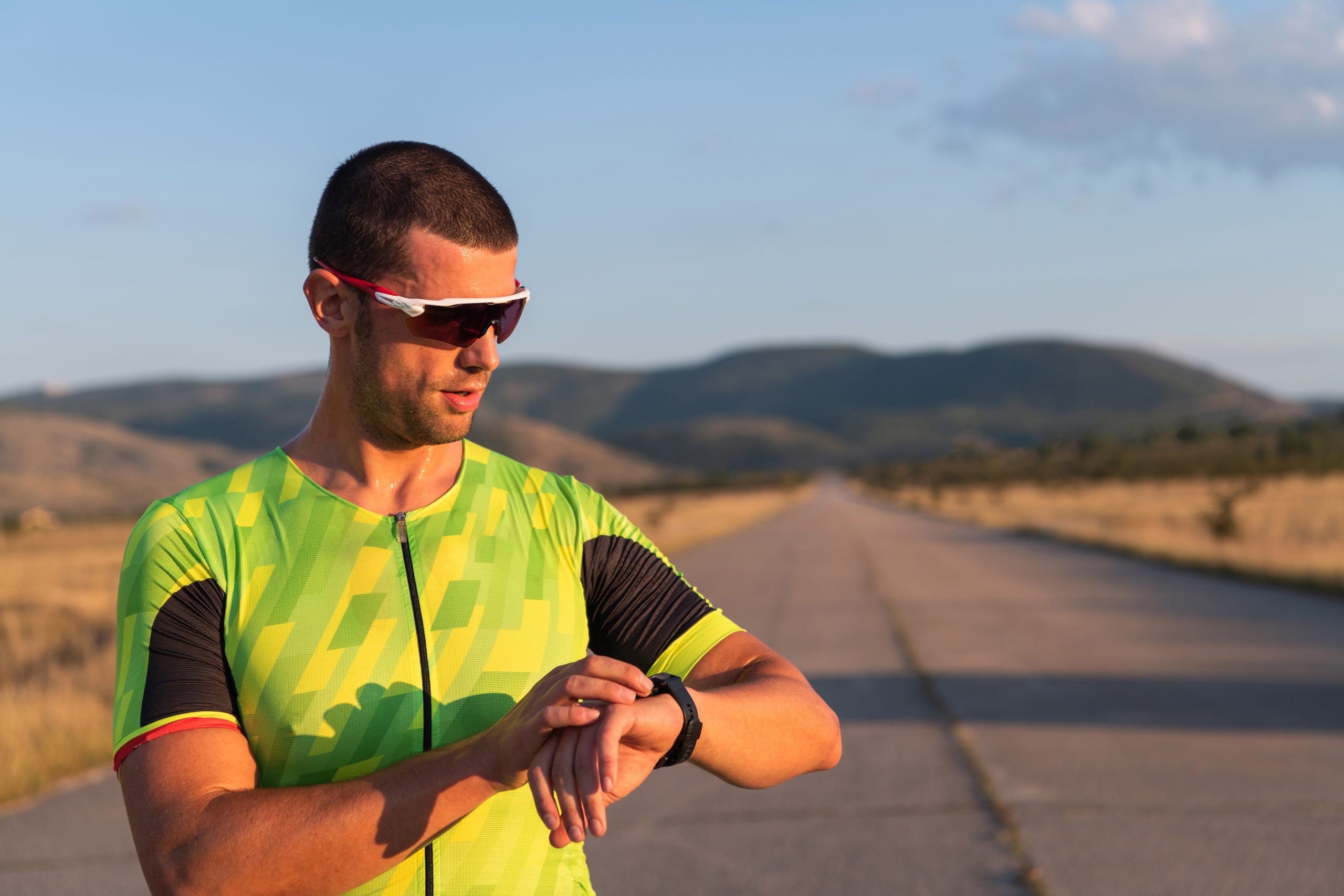 A runner on the road takes a break to check his vitals on a smartwatch after experimenting with an oral appliance for sleep apnea.